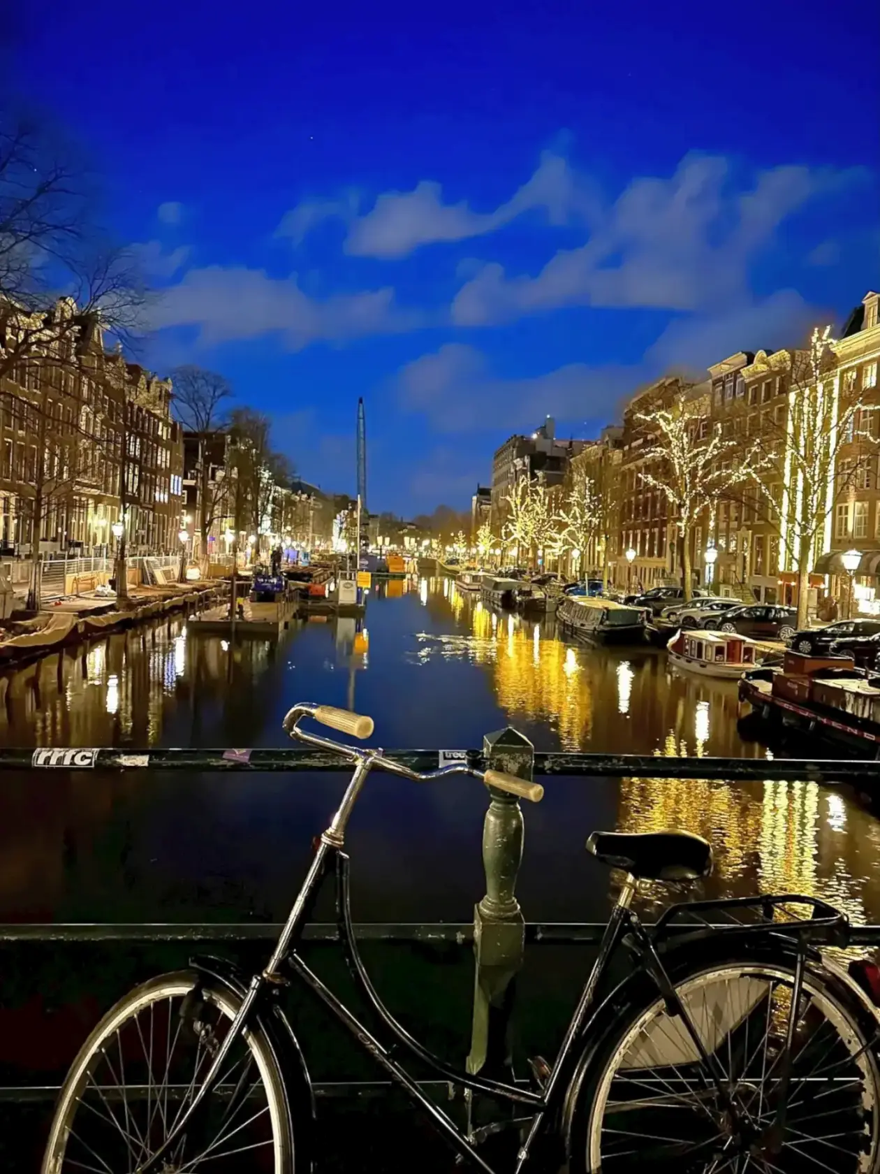 Bicycle on Amsterdam’s canal bridge. Living Netherlands’ gezelligheid -- Azzurytt Local Rhythm