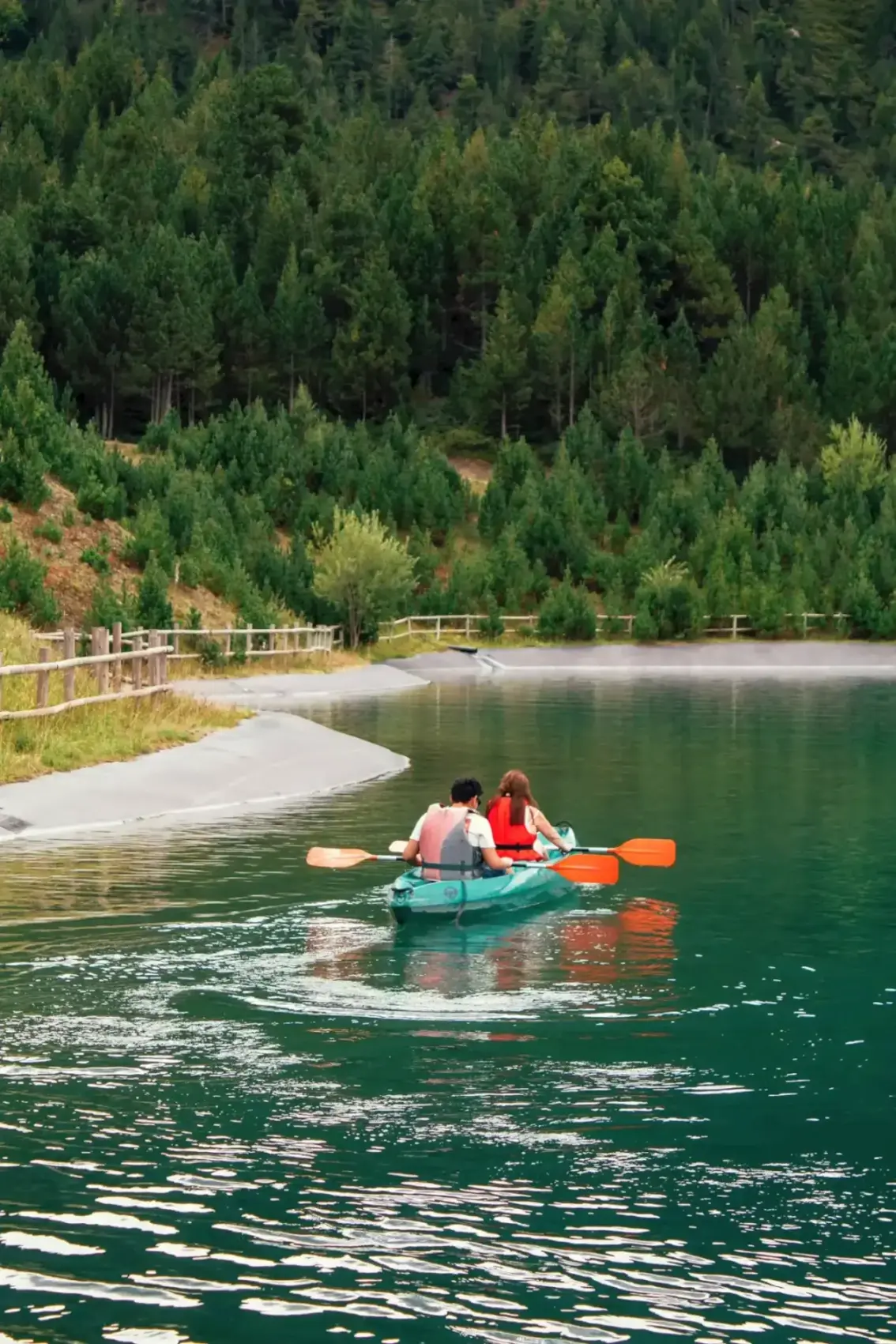 Couple in a canoe on a lake in Andorra. Europe Great Outdoors -- Azzurytt Nature Boating