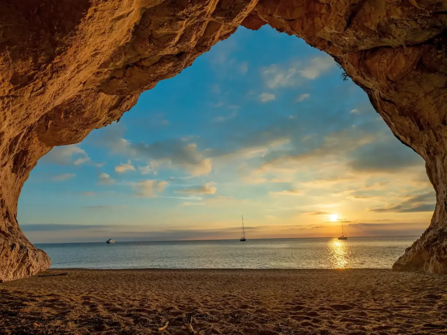 Sunset in Cala Luna beach cave, Sardinia. Yachting in Italy -- Azzurytt Coastal Serenity