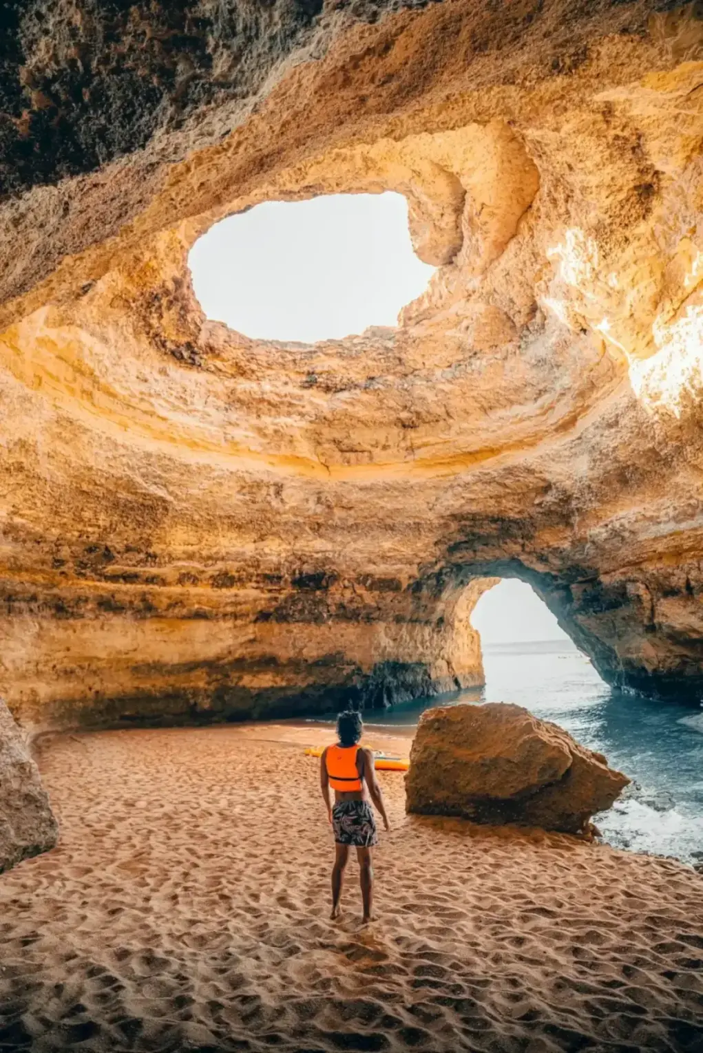 Surfer on Praia de Benagil, Carvoeiro. Bespoke Portugal Itinerary -- Azzurytt Discreet Travel