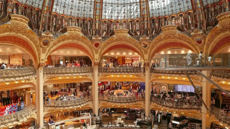 Gilded balconies of Galeries Lafayette Haussmann in Paris. Bespoke France Itineraries -- Azzurytt Cultural Heritage