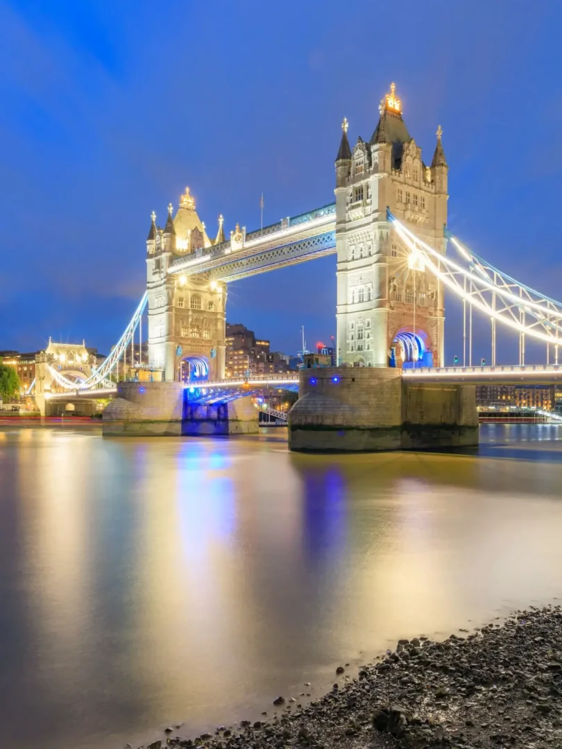 Tower Bridge illuminated at night over the Thames. London’s skyline in quiet evening light -- Azzurytt Nocturnal Elegance